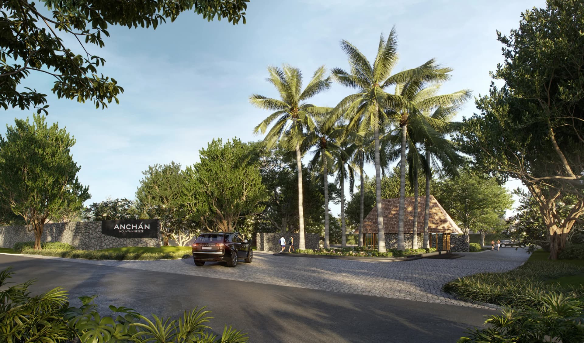 The estate entrance: palm-lined road, stone wall with the Anchan sign and the cedar-roofed gatehouse